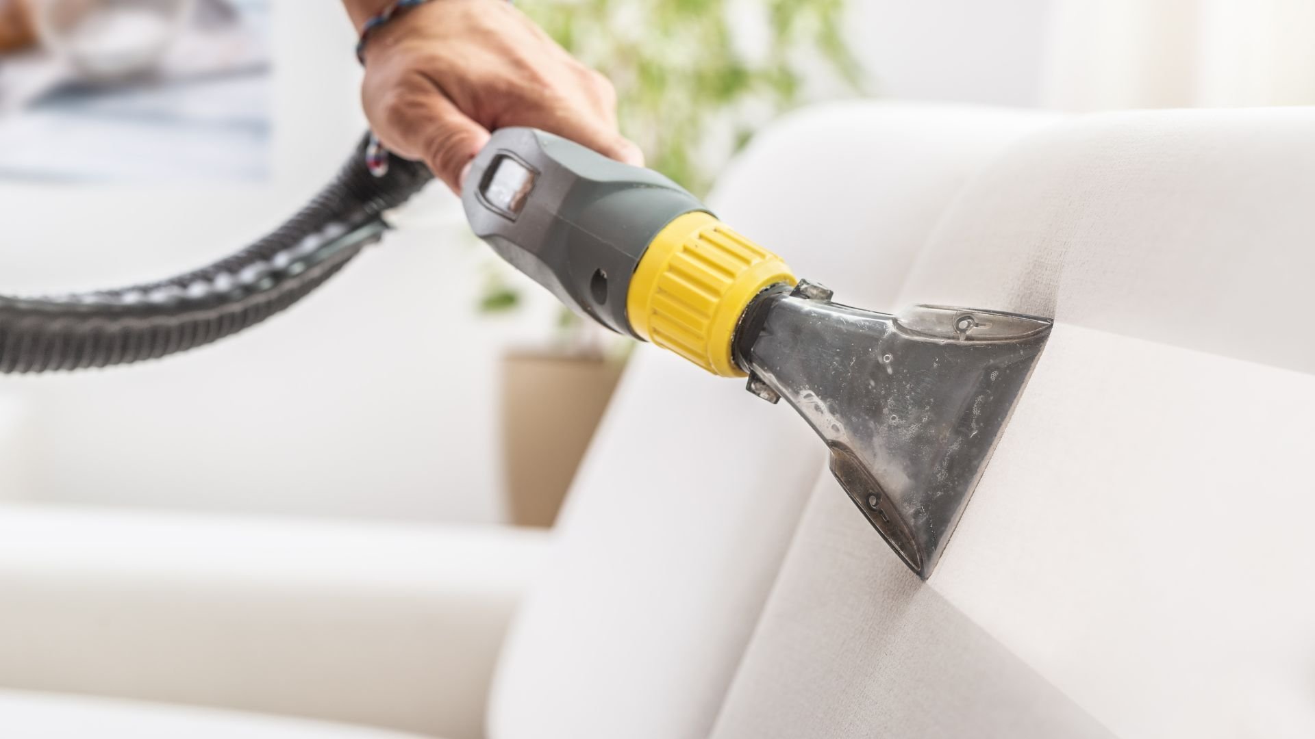 Vacuum cleaner attachment cleaning white upholstery or furniture
